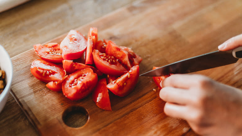 Slicing tomato with sharp knife
