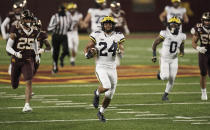 Michigan running back Zach Charbonnet (24) carries for a touchdown against Minnesota in the first half of an NCAA college football game Saturday, Oct. 24, 2020, in Minneapolis. (Mark Vancleave/Star Tribune via AP)