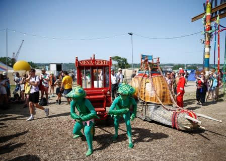 Protestors affiliated with Extinction Rebellion take part in a procession during Glastonbury Festival at Worthy farm in Somerset