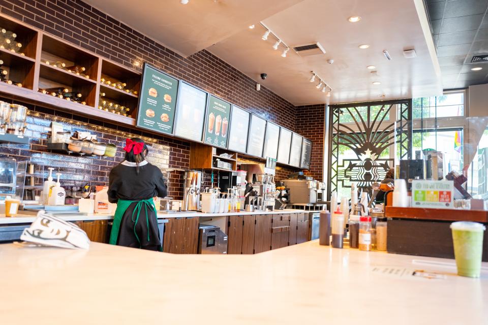 Low-angle view of drink order and mobile order pickup area at Starbucks coffee with baristas visible working behind a counter, Alameda, California, October 16, 2021. Photo courtesy Sftm. (Photo by Gado/Getty Images)