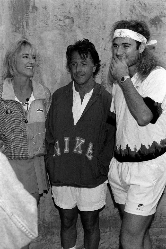 Dustin Hoffman (center) in a Nike pullover with Chris Evert Lloyd and Andre Agassi at the Volvo Celebrity Tennis Tournament in L.A. on August 3, 1993. - Credit: Fairchild Publishing