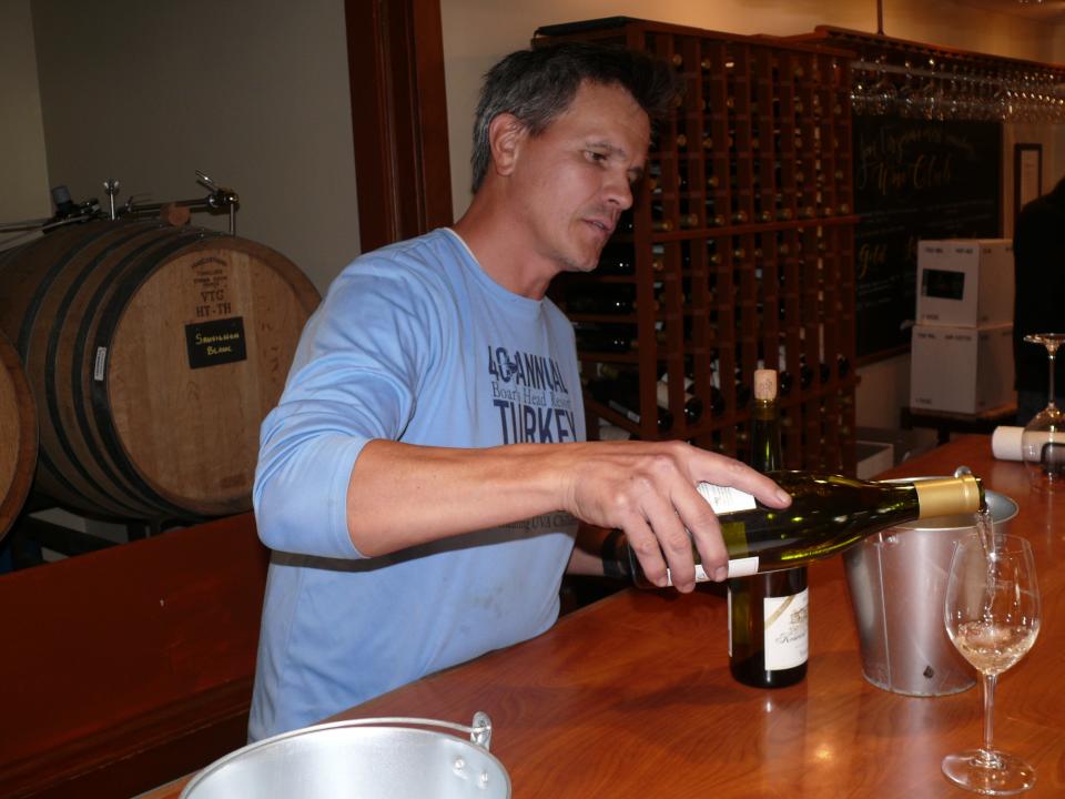 Stephen Barnard of Keswick Vineyards in Virginia pours wine in the vineyard's tasting room.