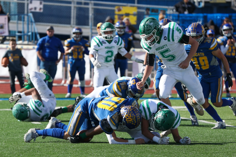 Bloomfield defensive back Andres Gordo (20) recovers a fumble by Moriarty running back Michael Magoffe (33) in the second quarter of the State 4A quarterfinal game on Saturday, November 12, 2022 at Bobcat Stadium.