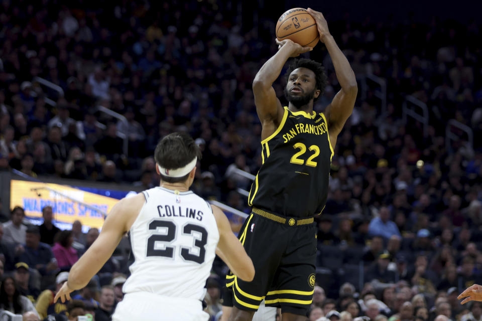 Golden State Warriors forward Andrew Wiggins (22) shoots against San Antonio Spurs forward Zach Collins (23) during the first half of an NBA basketball In-Season Tournament game in San Francisco, Friday, Nov. 24, 2023. (AP Photo/Jed Jacobsohn)