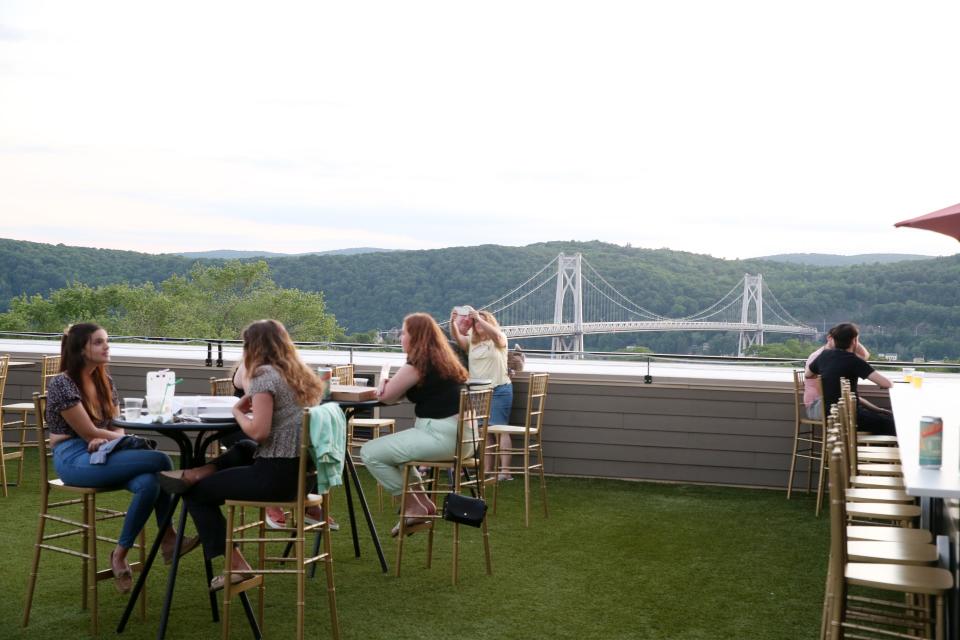 Patrons enjoy a meal on the rooftop bar at Zeus Brewing in the City of Poughkeepsie on June 10, 2021. 