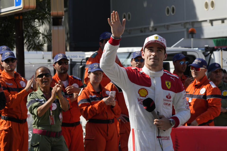 Ferrari driver Charles Leclerc of Monaco waves as he stands in the pit area at the end of the Formula One qualifying session at the Monaco racetrack, in Monaco, Saturday, May 27, 2023. The Formula One race will be held on Sunday. (AP Photo/Luca Bruno)