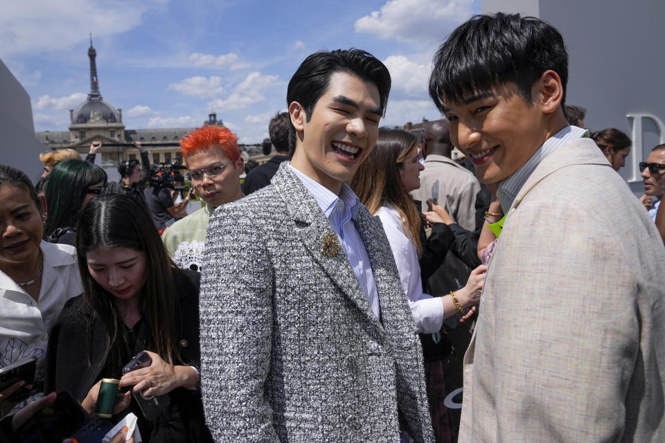 Nattawin Wattanagitiphat, left, and Mile Phakphum Romsaithong upon arrival at the Dior Menswear Spring/Summer 2024 fashion collection presented in Paris, Friday, June 23, 2023. (AP Photo/Michel Euler)