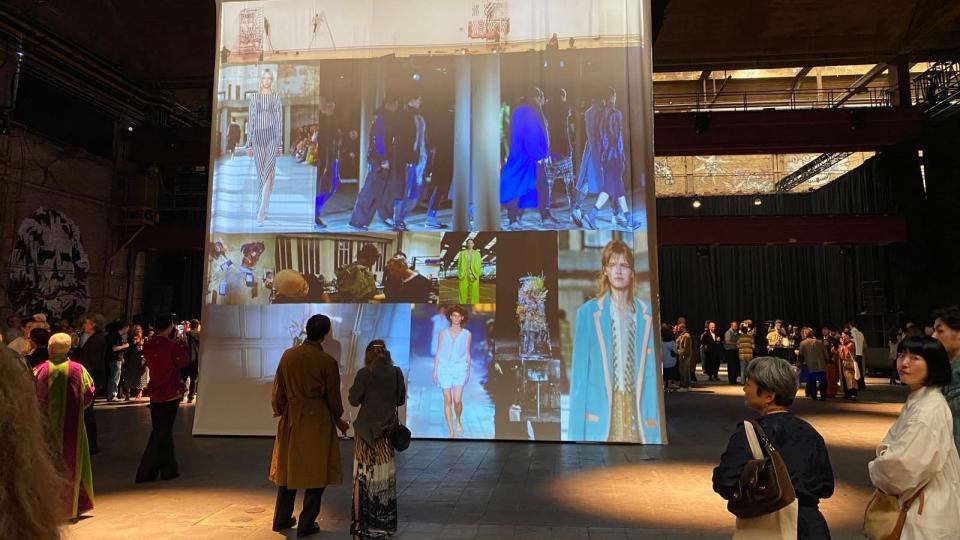 Images of Dries Van Noten's runways are displayed on a huge block in the centre of the room at the pre-show cocktail party