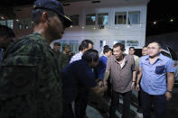 In this Jan. 23, 2020, photo provided by the Malacanang Presidential Photographers Division, Philippine President Rodrigo Duterte, center right, is greeted at the San Isidro Central School as he arrives to lead the distribution of benefits to former rebels in Leyte province, southern Philippines. Duterte has renewed a threat to terminate an accord that allows American forces to train in the country unless Washington restored a visa of a political ally linked to human rights violations. (Karl Norman Alonzo/Malacanang Presidential Photographers Division via AP)