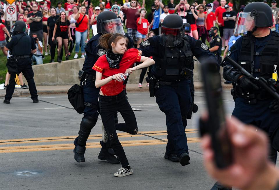 A protestor is pushed toward the sidewalk after refusing to leave the road during a protest against the overturning of Roe v. Wade on Wednesday, June 29, 2022, in Sioux Falls.