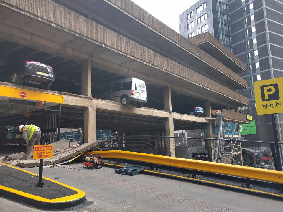 The NCP Nottingham City car park after a wall collapsed leaving vehicles hanging in mid-air: PA