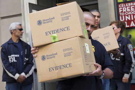 Law enforcement officers take evidence from the Manhattan offices of Rentboy.com in New York August 25, 2015. REUTERS/Brendan McDermid