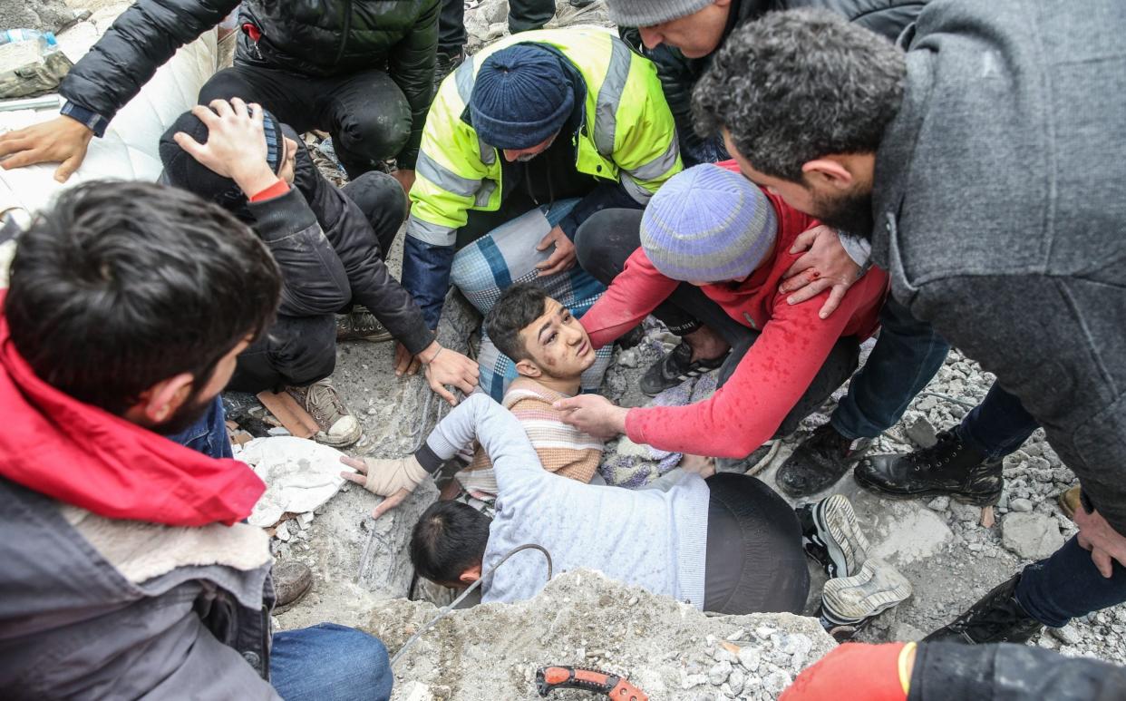 A young man is rescued from the rubble of a six-storey building that collapsed in the earthquake - Murat Sengul/Anadolu Agency via Getty Images