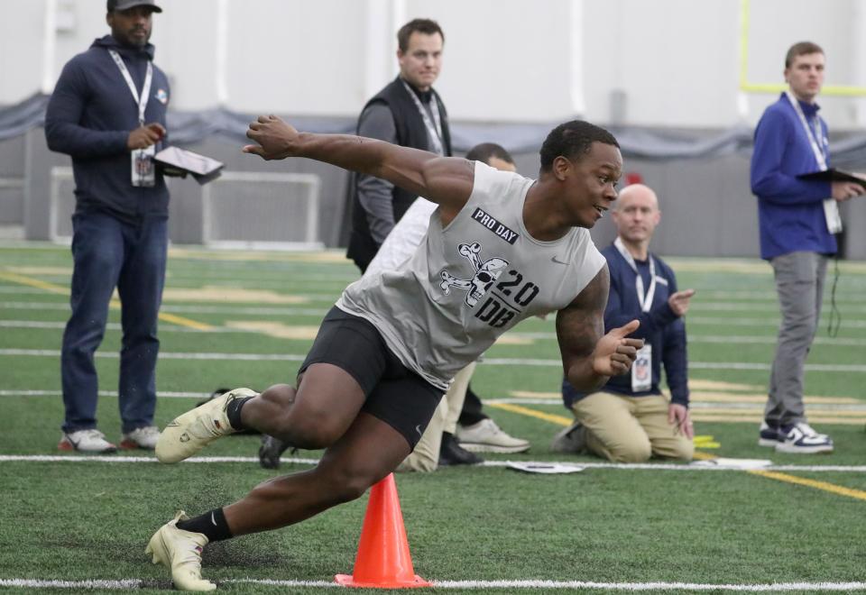 Pro football scouts watch Army's Marquel Broughton during pro day at West Point March 16, 2023.