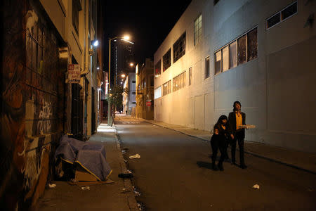 Isha Padhye, 23, a UI designer and Zander Dejah, 25, a Virtual Reality engineer, walk home from a night out in San Francisco, California, U.S. February 12, 2017. REUTERS/Gabrielle Lurie