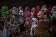 Relatives and neighbors wail during the funeal of Waseem Ahmed, a policeman who was killed in a shootout, on the outskirts of Srinagar, Indian controlled Kashmir, Sunday, June 13, 2021. Two civilians and two police officials were killed in an armed clash in Indian-controlled Kashmir on Saturday, police said, triggering anti-India protests who accused the police of targeting the civilians. (AP Photo/ Dar Yasin)