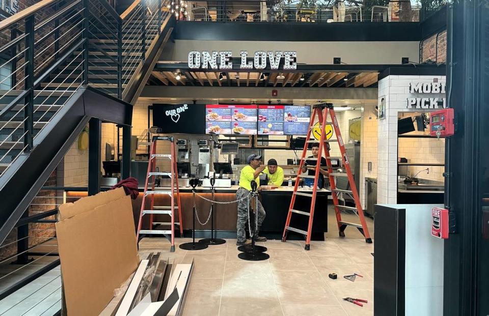 Construction workers take a lunch break on Oct. 11, 2023, at the new Raising Cane’s location on East Franklin Street in Chapel Hill. The long-awaited restaurant will open Nov. 7, company officials said.