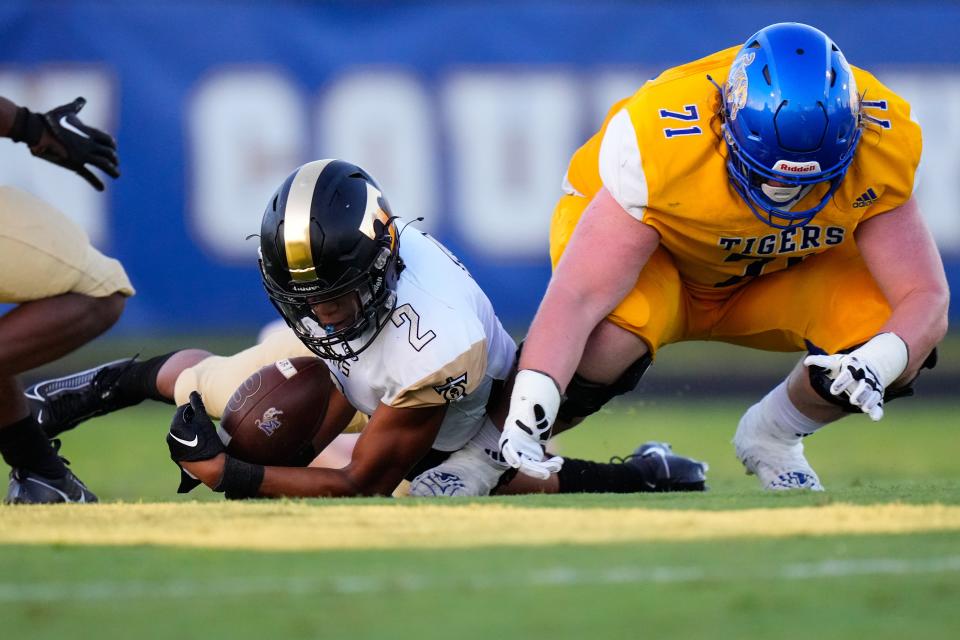 Treasure Coast defensive end Omari Kinsler (2) recovers a fumble against Martin County in a high school football game on Thursday, Sept. 14, 2023, at Martin County High School.