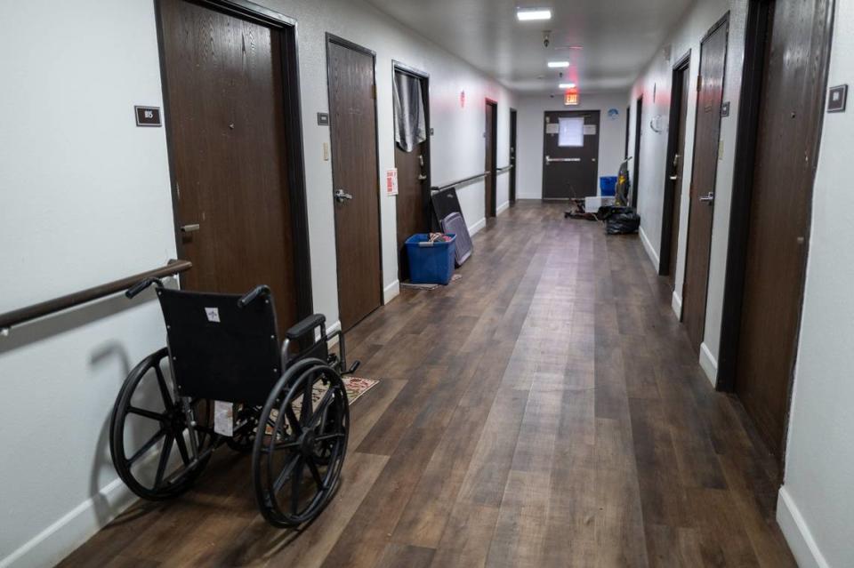 A wheelchair and containers packed with residents’ belongings rest in the hallway in March at the Auburn Oaks complex where senior and disabled residents were being evicted by Next Move Homeless Services, which has received about $837,000 in county funds to fund the facility since 2020.