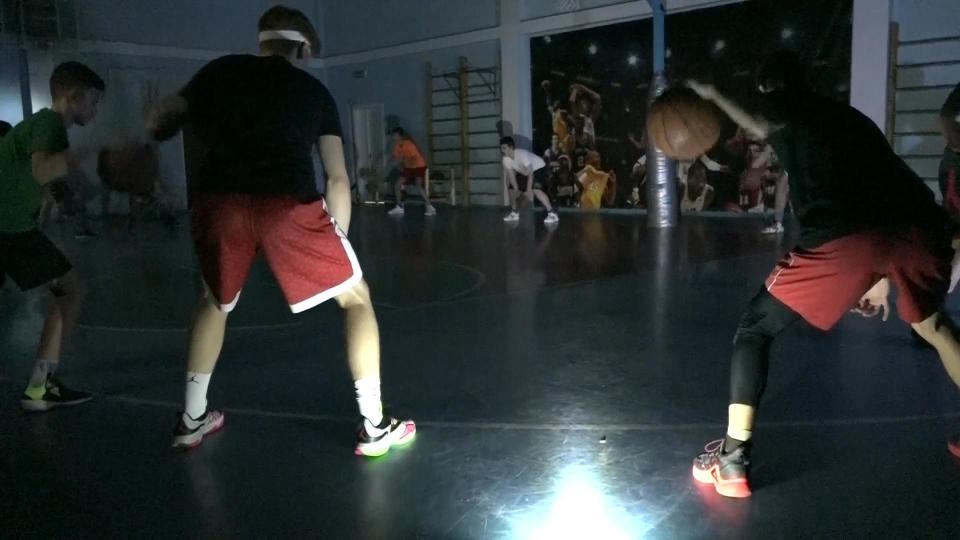 Practicing in a dark Ukrainian gym with the light of cell phones. 