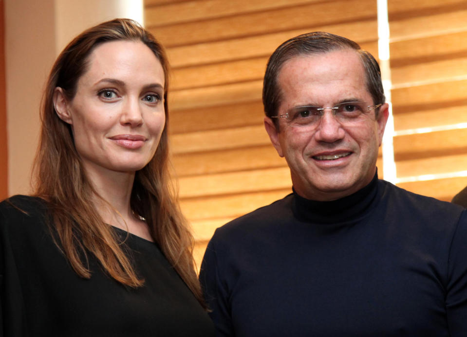 In this photo released by Ecuador's Foreign Ministry, Ecuador's Foreign Minister Ricardo Patino, right, and U.S. actress and UNHCR's Goodwill Ambassador Angelina Jolie pose for pictures during a meeting in Quito, Ecuador, Sunday, April 22, 2012. Jolie met on Sunday Patino to start the campaign "Thanks Ecuador," promoted by the Office of the United Nations High Commissioner for Refugees, UNHCR, in recognition of the work of the Andean country in support of refugees. (AP Photo/Xavier Granja, Ecuador's Foreign Minister)