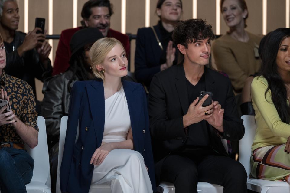 wearing a structured blazer over a dreamy evening gown, Anna sits front row at her friend's fashion show