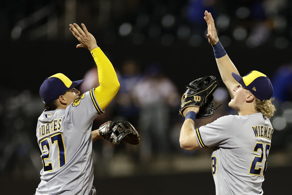 Milwaukee Brewers center fielder Joey Wiemer, right, celebrates with Willy Adames (27) after they defeated the New York Mets in a baseball game, Monday, June 26, 2023, in New York. (AP Photo/Adam Hunger)