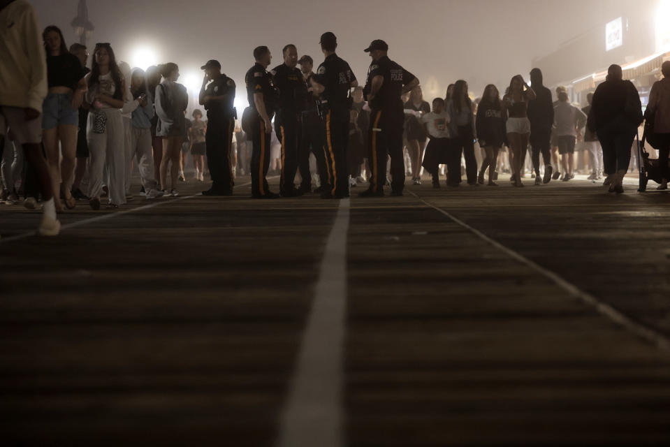 Police watch the crowds on the boardwalk in Ocean City, N.J., on Memorial Day weekend, Sunday, May 26, 2024. On Wednesday, May 29, New Jersey’s statewide police union called for changes in laws and policies governing police interactions with disorderly young people following disturbances that led to the temporary closure of the boardwalk in Wildwood, and the stabbing of a 15-year-old boy in Ocean City. (Elizabeth Robertson/The Philadelphia Inquirer via AP)