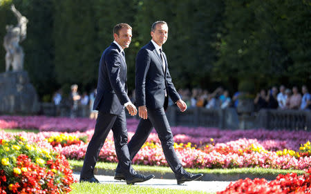 French President Emmanuel Macron (L) and Austrian Chancellor Christian Kern leave a photo opportunity in Salzburg, Austria, August 23, 2017. REUTERS/Heinz-Peter Bader