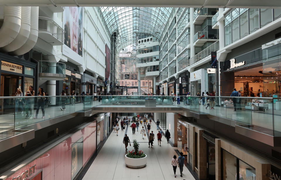 TORONTO, ONT - JULY 26: People walk though the Eaton Center shopping mall on July 26, 2023, in Toronto, Canada.  (Photo by Gary Hershorn/Getty Images)