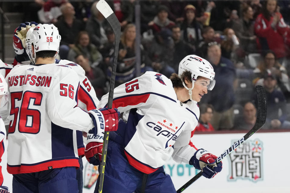 Washington Capitals left wing Sonny Milano (15) smiles after celebrating his goal against the Arizona Coyotes with teammates, including defenseman Erik Gustafsson (56), during the second period of an NHL hockey game in Tempe, Ariz., Thursday, Jan. 19, 2023. (AP Photo/Ross D. Franklin)