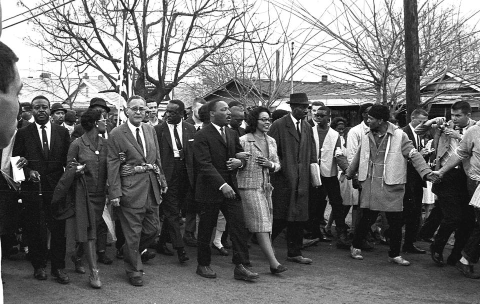 American Civil Rights leader Dr. Martin Luther King Jr. (1929 - 1968) and his wife Coretta Scott King (1927 - 2006) (center, arm in arm) lead others during on the Selma to Montgomery marches held in support of voter rights, Alabama, late March, 1965. Among those with them are Reverend Ralph Abernathy (1926 - 1990) (at left, facing camera), and Pulitzer-Prize winning political scientist and diplomat Ralph Bunche (1904 - 1971) (front row, third left with glasses) whose his wife, Ruth (nee Harris, 1906 - 1988), holds his arm. (Photo by Robert Abbott Sengstacke/Getty Images) 