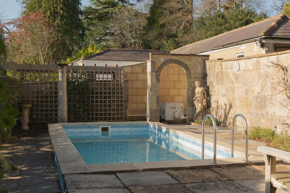 The property has an outdoor swimming pool and mature gardens (Savills)