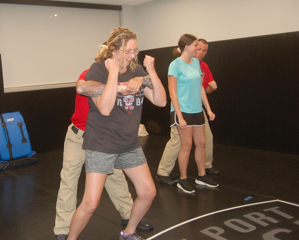 Beth Kersten and her daughter Melanie practice escape moves during a women's self-defense class sponsored by the North Port Police Department. “Always maintain your situational awareness,’’ NPPD instructor Jarod Peer said.