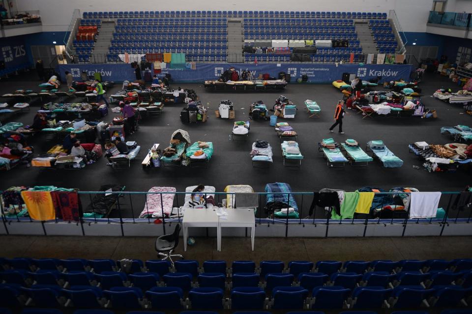 People fleeing Ukraine rest inside the temporary shelter organized in a sports hall in Krakow, Poland, on March 15, 2022. <a href="https://www.gettyimages.com/detail/news-photo/people-fleeing-from-ukraine-rest-inside-the-temporary-news-photo/1239228005?phrase=ukraine%20refugees%20camps%20poland&adppopup=true" rel="nofollow noopener" target="_blank" data-ylk="slk:Jakub Porzycki/NurPhoto via Getty Images;elm:context_link;itc:0;sec:content-canvas" class="link ">Jakub Porzycki/NurPhoto via Getty Images</a>