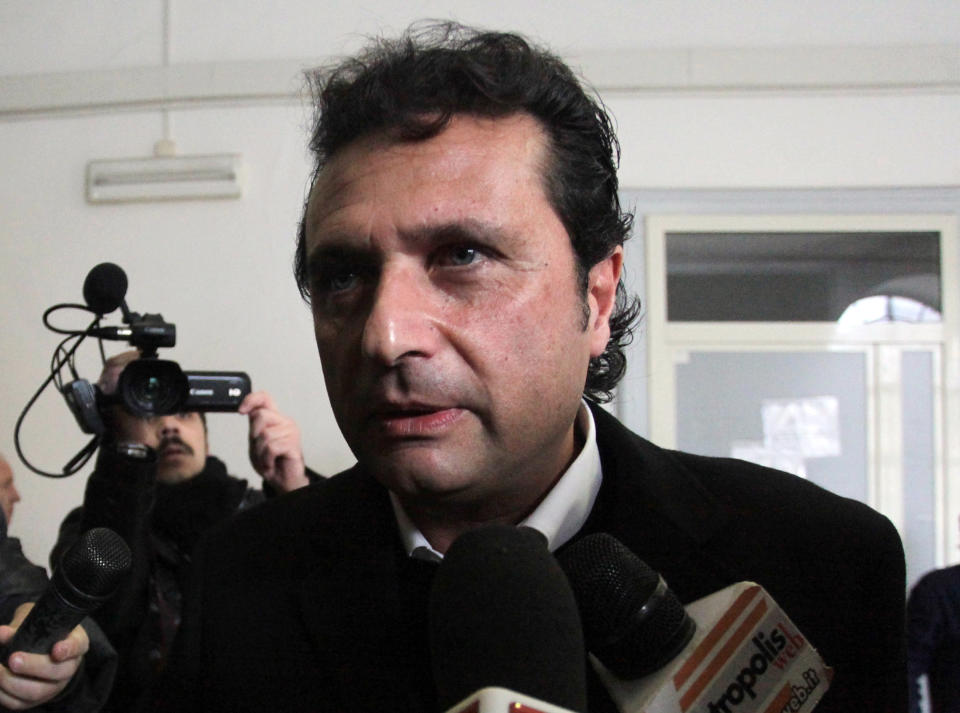 FILE -- In this photo from files taken in Naples on Jan. 30, 2013, Captian Francesco Schettino speaks to the media. The Italian captain of the Costa Concordia cruise ship was ordered on Wednesday to stand trial for manslaughter in the luxury liner's shipwreck off the coast of Tuscany, which killed 32 people. Judge Pietro Molino, at a closed door hearing in the town of Grosseto, agreed to prosecutors' requests that Francesco Schettino should be tried on charges of manslaughter, causing the shipwreck and abandoning the vessel while many of the 4,200 passengers and crew were still aboard. (AP Photo/Salvatore Laporta)