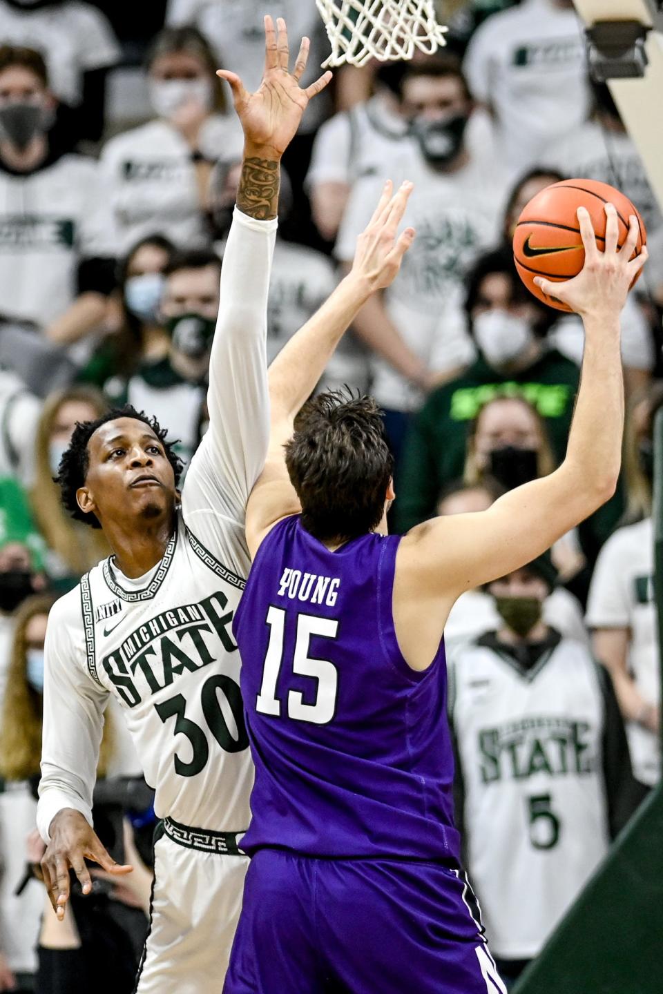 Michigan State's Marcus Bingham Jr., left, pressures Northwestern's Ryan Young on a shot during the first half on Saturday, Jan. 15, 2022, at the Breslin Center in East Lansing.