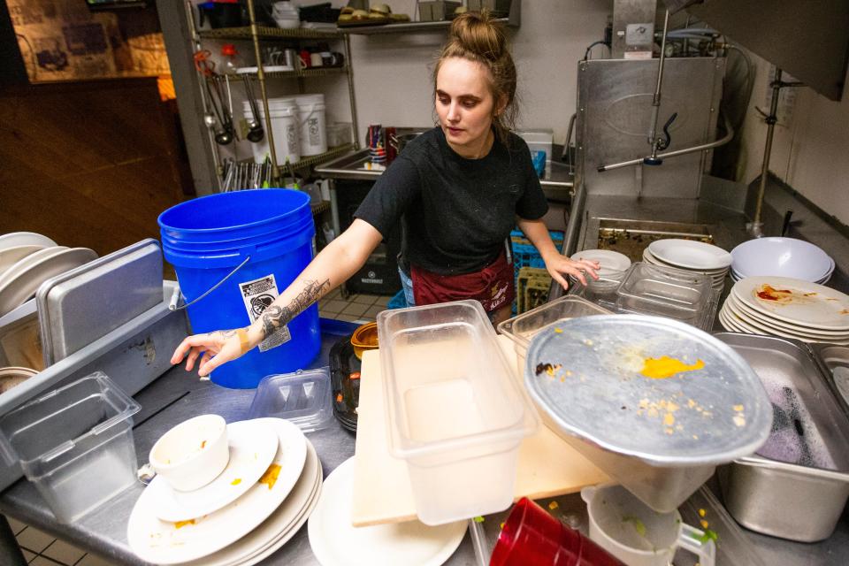 Cheyenne Turner works on dishes Monday, June 13, 2022, at Taphouse on the Edge in South Bend.