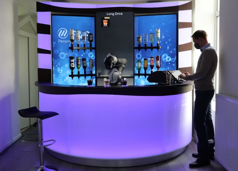 F&P Robotics CSO Colombo taps a display to order a drink at the Barney Cocktail Bar in Zurich