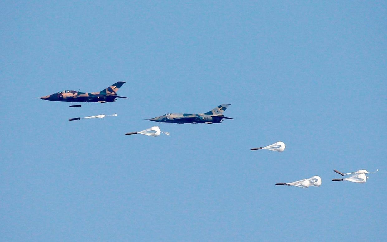 Chinese-made A-5 attack aircraft drop bombs during exercises  - AFP