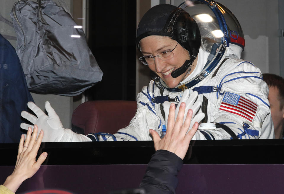 U.S. astronaut Christina Hammock Koch, member of the main crew of the expedition to the International Space Station (ISS), gestures to her relatives from a bus prior the launch of Soyuz MS-12 space ship at the Russian leased Baikonur cosmodrome, Kazakhstan, Thursday, March 14, 2019. (AP Photo/Dmitri Lovetsky, Pool)