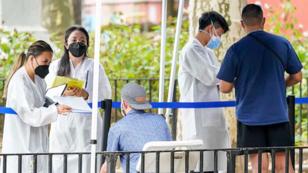 PHOTO: Healthcare workers with New York City Department of Health and Mental Hygiene help people register for the monkeypox vaccine at one of the City's vaccination sites, on July 26, 2022, in New York. (Mary Altaffer/AP)