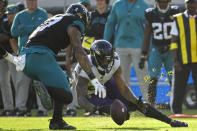 Baltimore Ravens cornerback Marcus Peters (24) recovers a fumble thrown by Jacksonville Jaguars quarterback Trevor Lawrence (16) during the second half of an NFL football game, Sunday, Nov. 27, 2022, in Jacksonville, Fla. (AP Photo/Phelan M. Ebenhack)