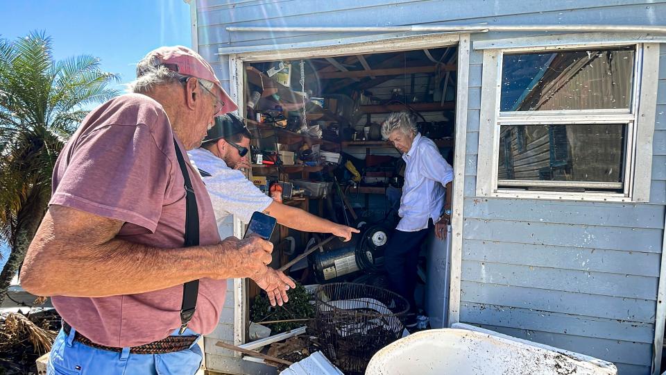 Friend Lazaro Ulpion points to the water line as Kiko and Gordie take stock of their small shed. Agust’n "Kiko" and Julia "Gordie" Villalon, long time Pine Island residents, returned to their Island home for the first time since evacuating before Hurricane Ian. Monday, September 03, 2022, they got to find out just how much damage there was.