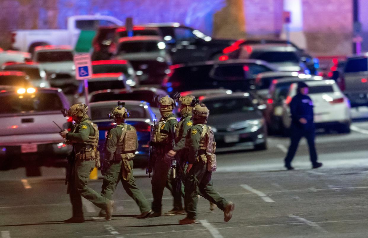 Law enforcement agents walk in the parking lot of a shopping mall, Wednesday, Feb. 15, 2023, in El Paso, Texas (AP)