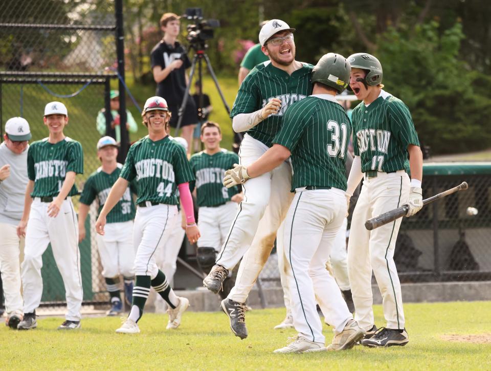 Abington's Connor O'Donnell (No. 31) is greeted by teammate Stephen Madden at home plate after hitting an RBI triple in the second inning and scoring on an error on the relay throw to third base. Abington hosted Norwell on Wednesday, May 24, 2023.