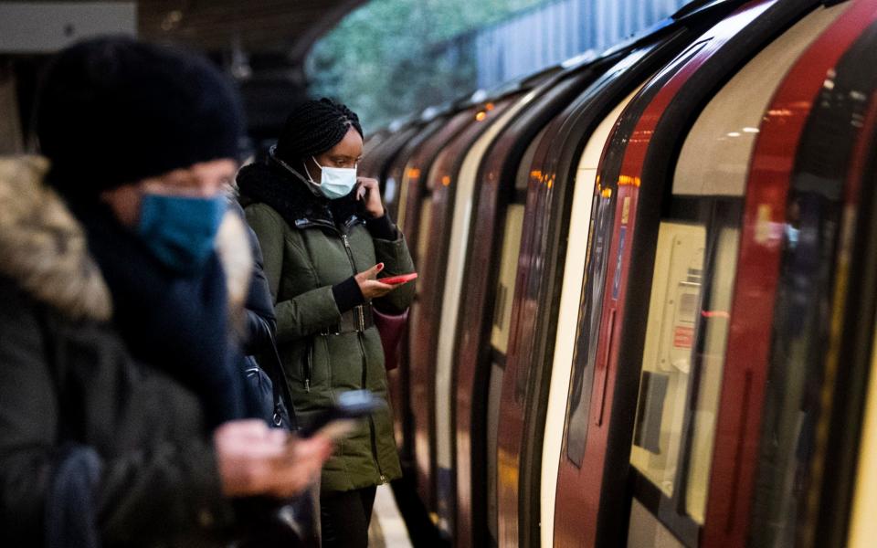 Commuters getting on a Jubilee Line Underground train at Canning Town station during the morning rush hour in London, as England's third national lockdown to curb the spread of coronavirus continues.  - Victoria Jones/PA