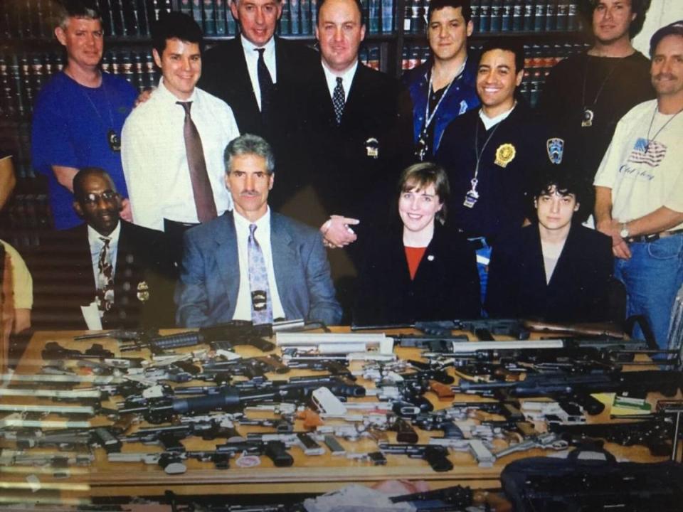 Then-Detective Felipe Rodriguez and his old team at the New York Police Department pose with seized guns in 2001. Today, Rodriguez is a professor, and he says the illegal gun market has made it much harder to trace where weapons came from.