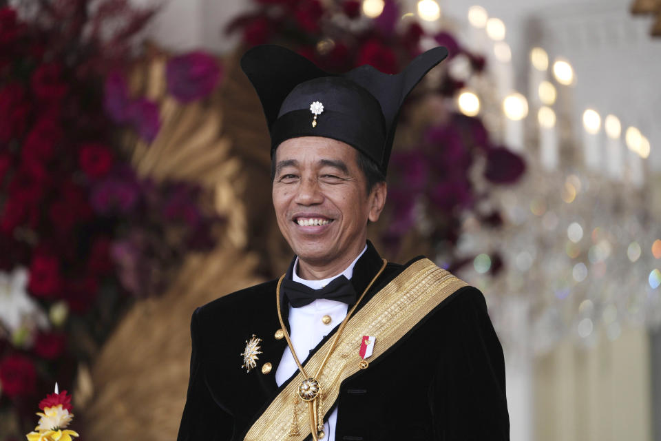 FILE - Indonesian President Joko Widodo, dressed in traditional Central Javanese royalty outfit, smiles during a ceremony marking the country's 78th anniversary of independence at Merdeka Palace in Jakarta, Indonesia, on Aug. 17, 2023. Widodo's phenomenal rise from a riverside slum, where he grew up, to the presidency of Indonesia spotlighted how far the world's third-largest democracy had veered from a brutal authoritarian era a decade ago. With his second and final five-year term ending in October, Widodo, regarded by some as Asia's Barack Obama, is leaving a legacy of impressive economic growth and an ambitious array of infrastructure projects including a $33 billion plan to relocate Indonesia's congested capital to the frontier island of Borneo. (AP Photo/Achmad Ibrahim, File)