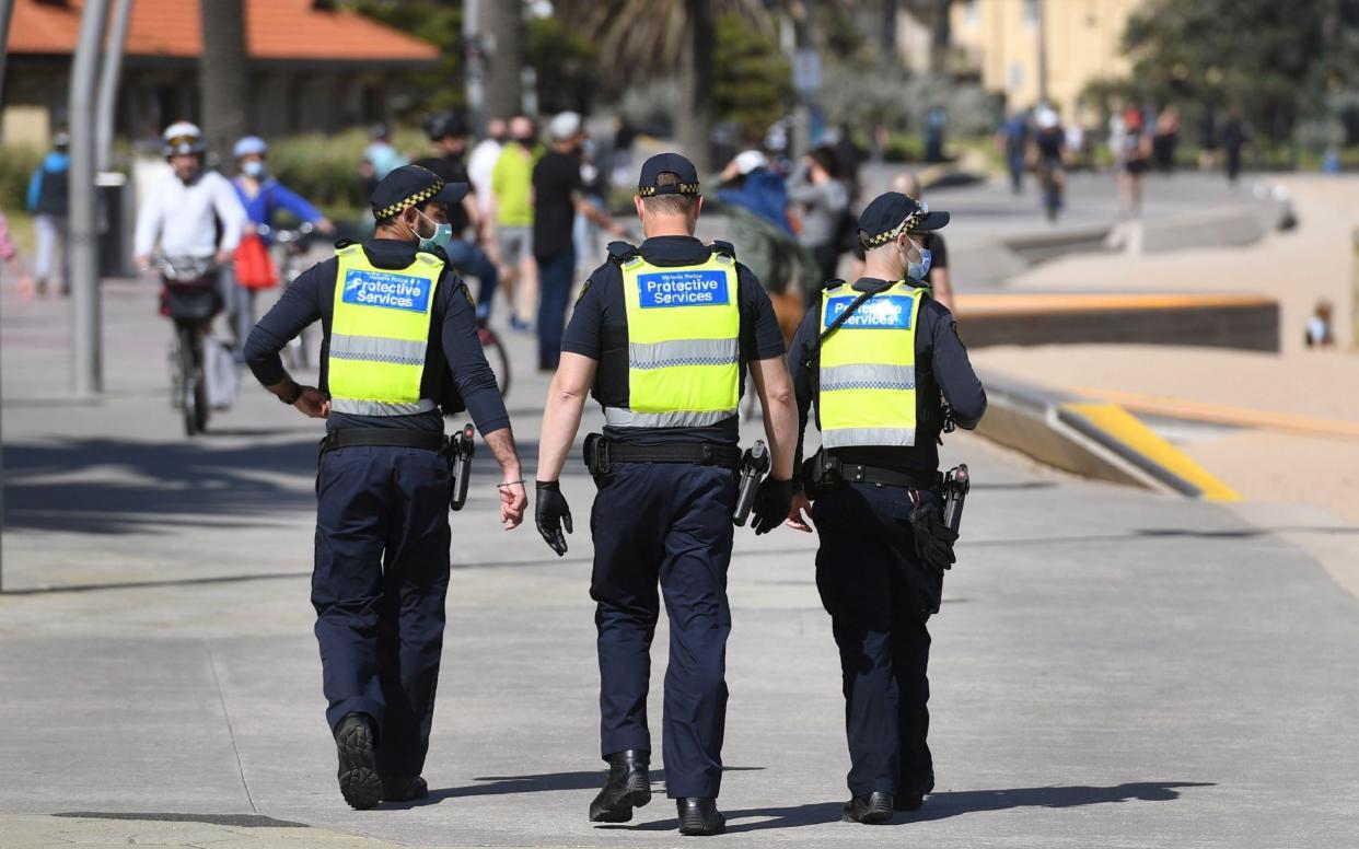 Protective services officers patrol along the St Kilda Beach foreshore in Melbourne - AFP 